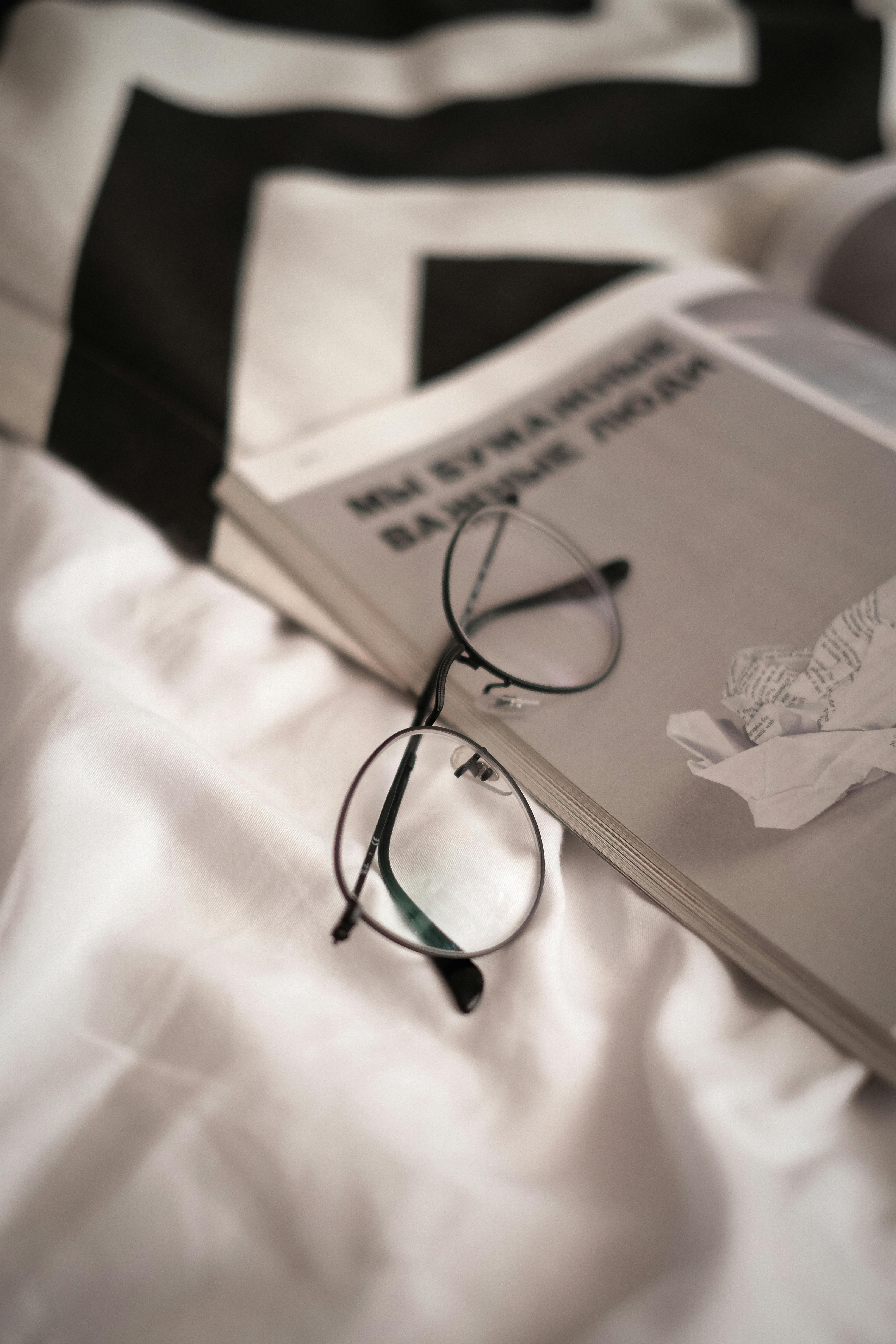 Stylish eyeglasses rest on an open newspaper, creating a modern and relaxed vibe. Ideal for lifestyle and fashion contexts.