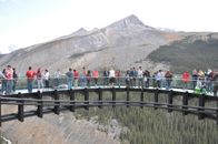 People Standing on the Bridge Near Mountain