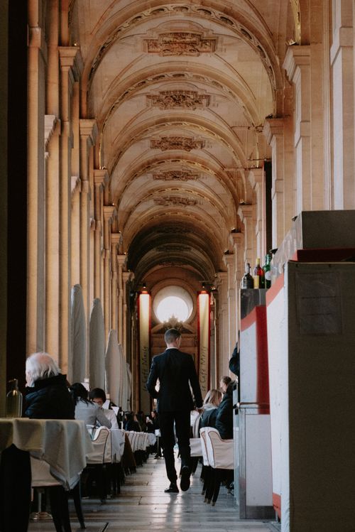 Free Sophisticated restaurant with arched ceilings, elegant decor, and patrons dining indoors. Stock Photo
