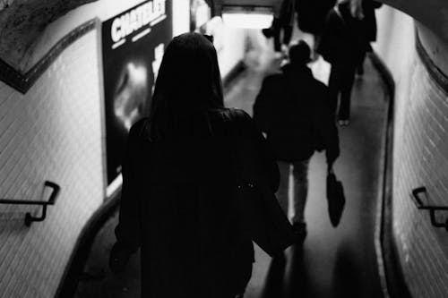 Back View Shot of People Walking on a Subway