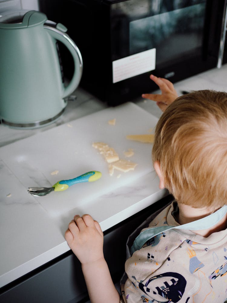 Toddler Playing With Food On The Table 