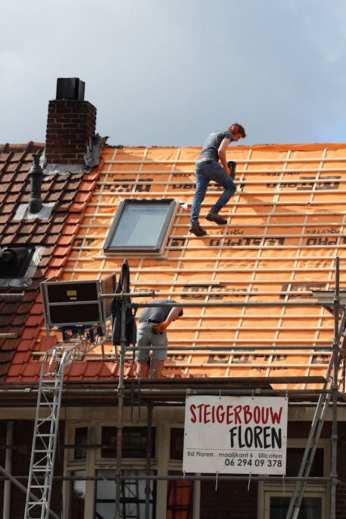 People Working on the Roof of an Establishment