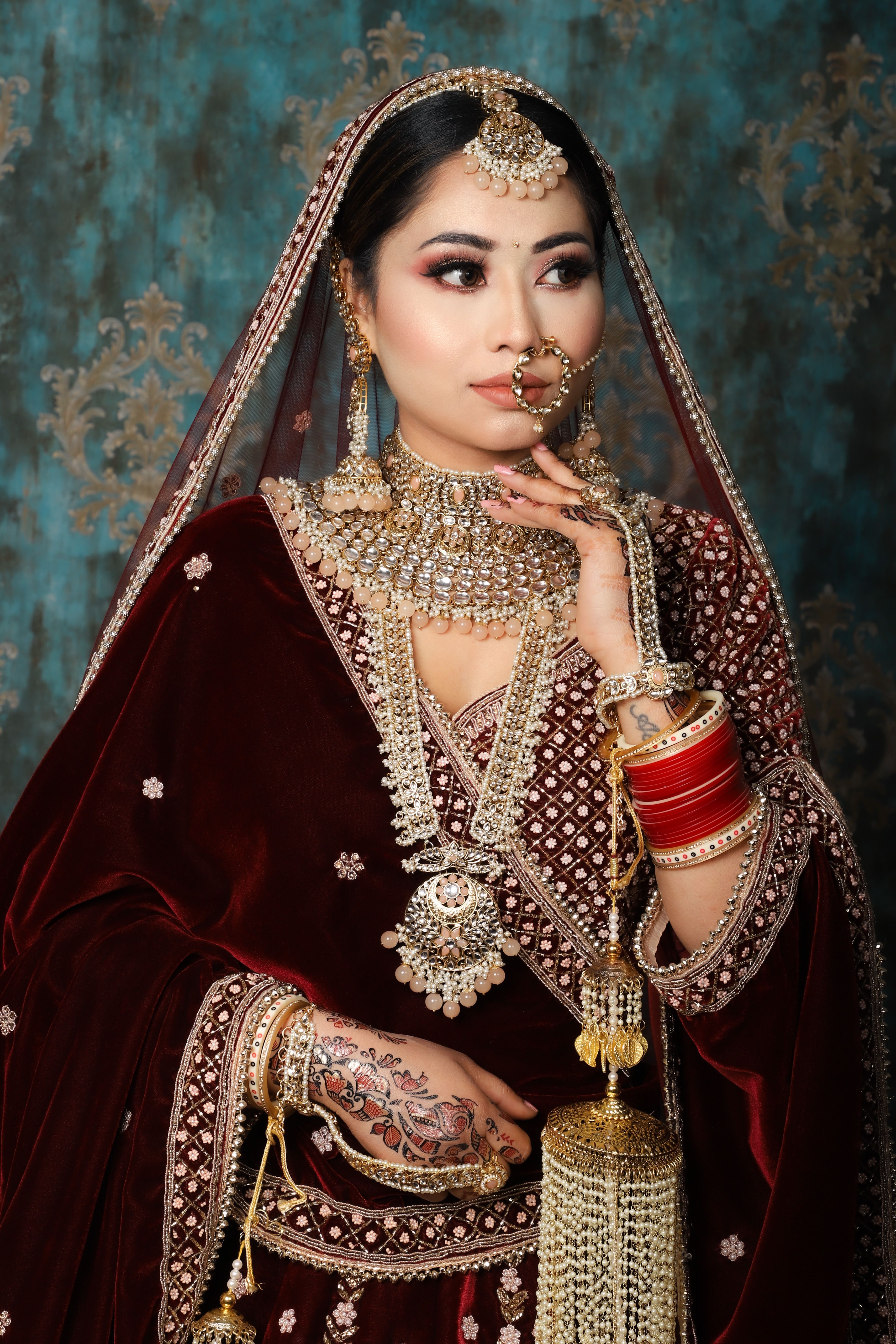 Beautiful portrait of a woman in traditional attire adorned with intricate jewelry and henna.