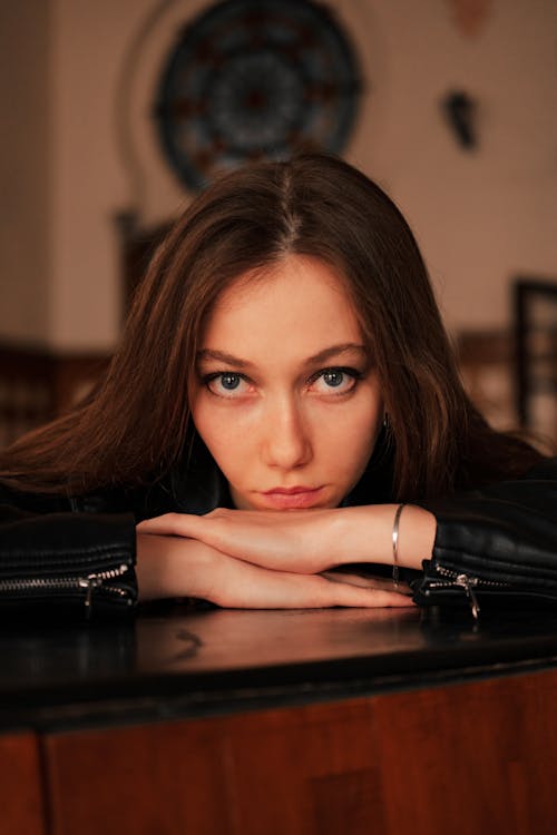 Portrait of Woman Resting Head on Table