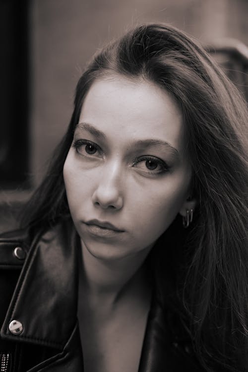 

A Grayscale of a Woman in a Leather Jacket