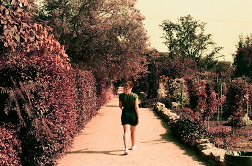 Woman Walking on Unpaved Path