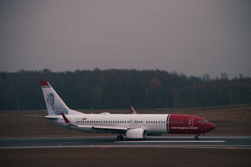 Photograph of a White and Red Airplane on the Runway