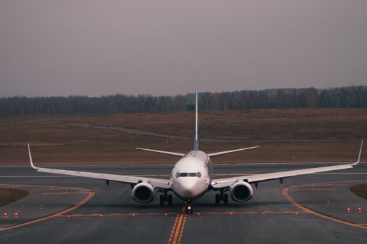 A commercial airplane taxiing on the runway at an airport in Vilnius, Lithuania.