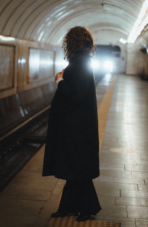 Woman in Black Coat Standing on Platform