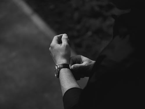 Free Grayscale Photo of a Person Wearing Wristwatch Stock Photo