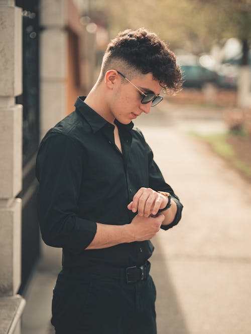 Man in Black Clothes Checking the Time