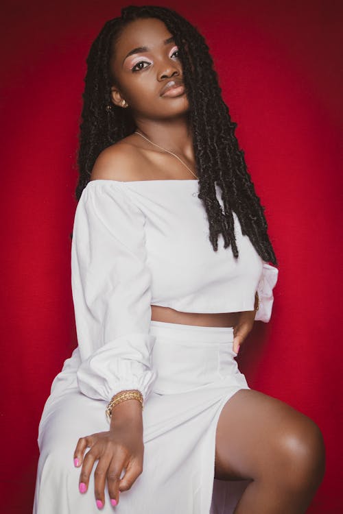Photo of a Woman with Dreadlocks Wearing White Clothes