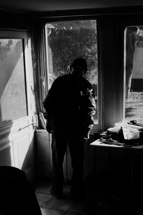 Free Grayscale Photo of Man Inside a House  Stock Photo
