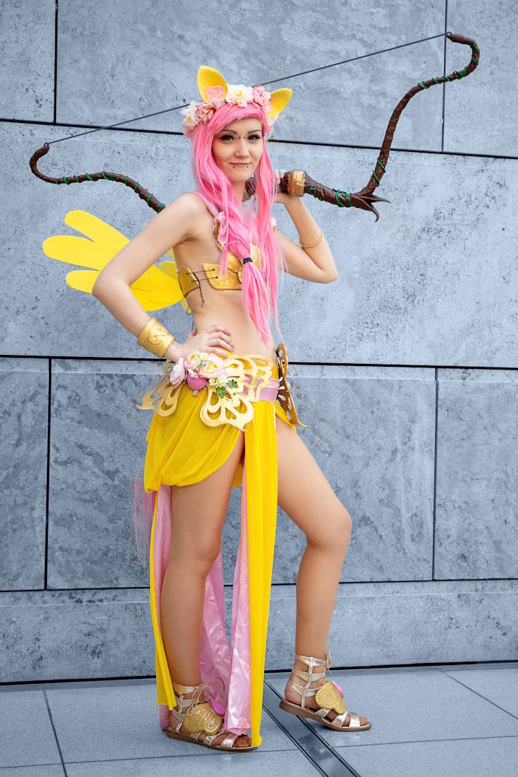 Photo Of A Woman With Pink Hair Posing With A Bow