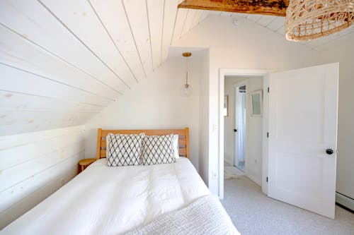 Photograph of a Room with a Bed and a White Door