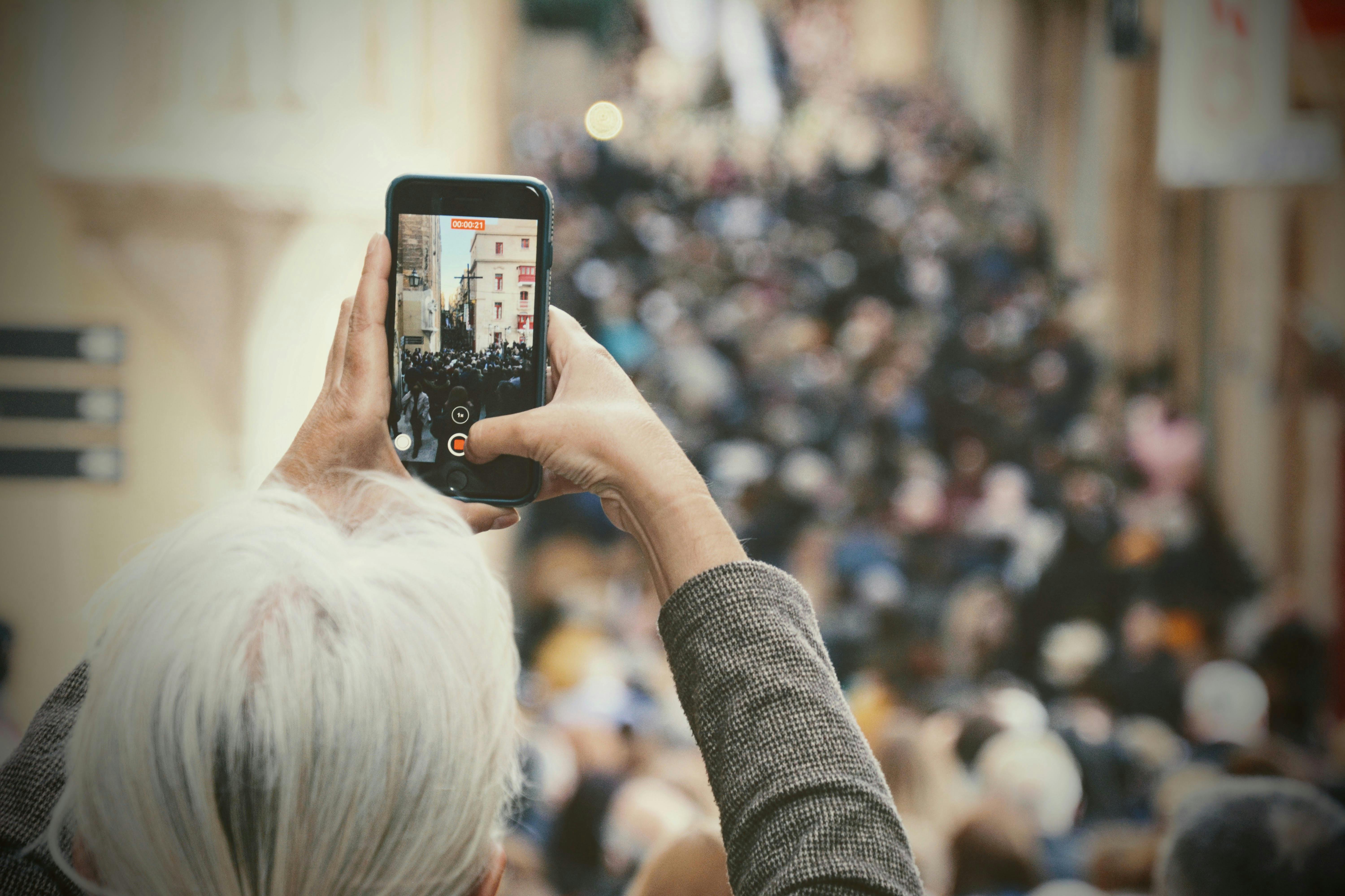 a person taking video of a religious celebration