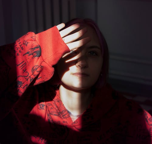 Photo of a Woman Covering Her Face from the Sunlight