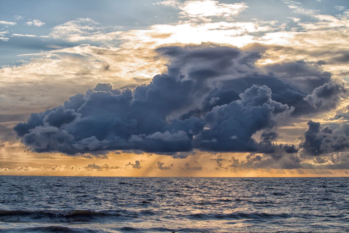 Photograph of a Sea Under Clouds · Free Stock Photo