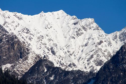 Free Stunning snowy mountain peaks under a clear blue sky, showcasing nature's winter beauty. Stock Photo