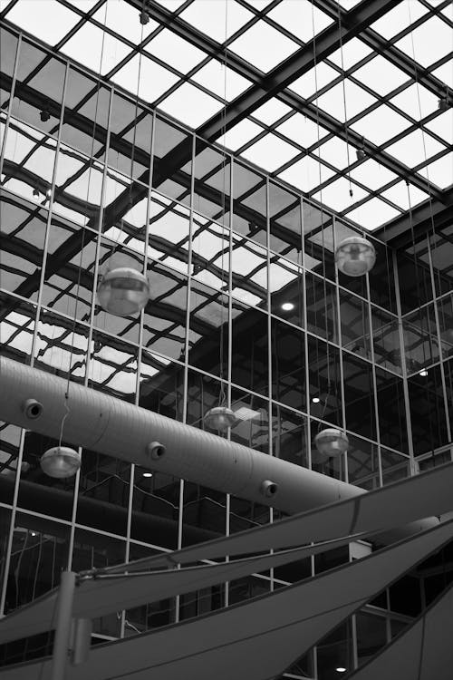 Grayscale Photo of Modern Architectural Design of a Ceiling