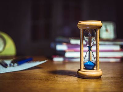 Hourglass on a wooden desk — photo by Mike on Pexels