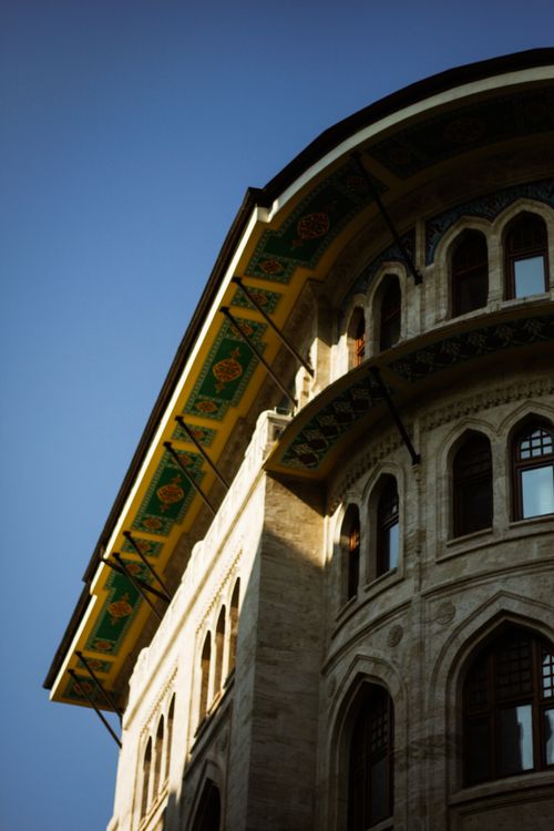 Free Low angle shot of a historical Ottoman-style building facade under clear blue skies. Stock Photo