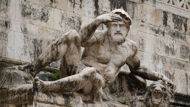 Imposing statue representing sea god in Rome's Piazza Venezia, Italy.
