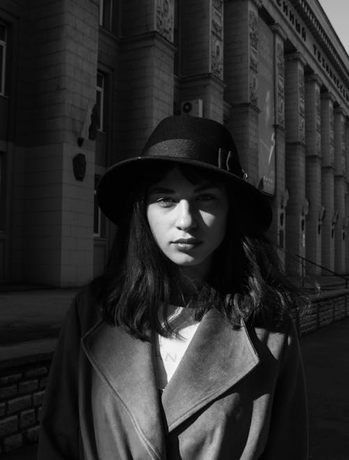 Grayscale Photo of a Woman Wearing a Hat