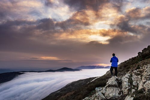 Free Person Looking at Sea of Clouds Stock Photo