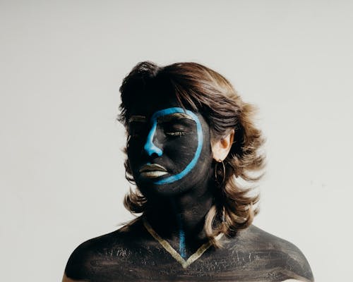 Portrait of Woman with Face Painted White and Blue