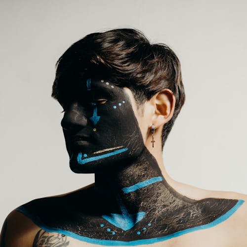Man with his Eyes Closed and Face Painted with Black and Blue Ink 