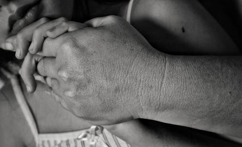 Free Grayscale Photograph of People Holding Hands Stock Photo