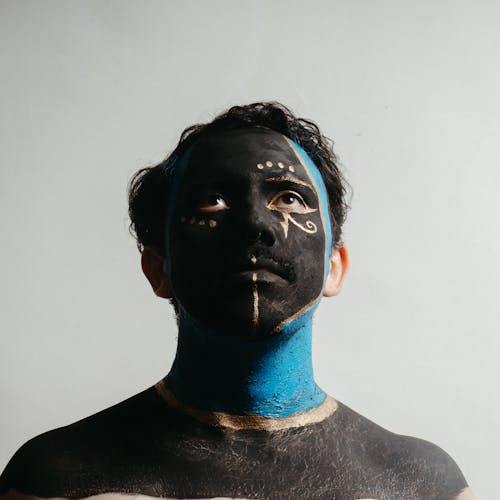 Man looking up with Black and Blue Face Paint