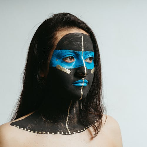 Close-up Photo of Woman with Artistic Face Paint 