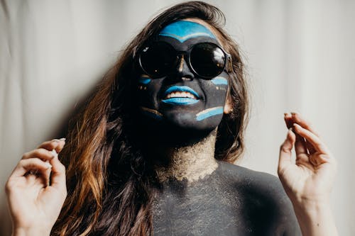Smiling Woman in Black Sunglasses and Body Paint