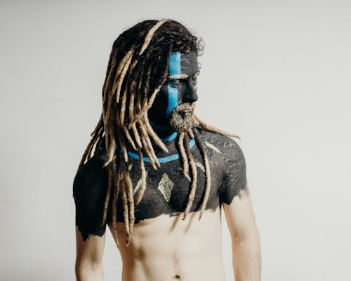Free Man with Artistic Body Paint and Dreadlocks  Stock Photo