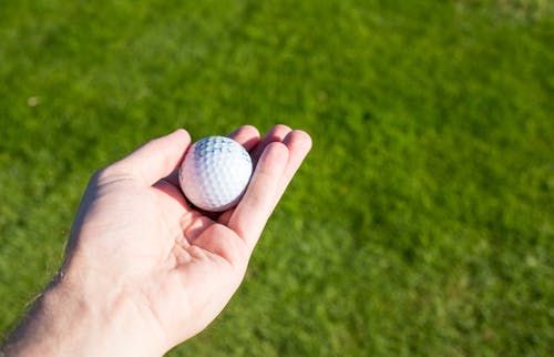 Free Golf Ball on Person's Hand Stock Photo