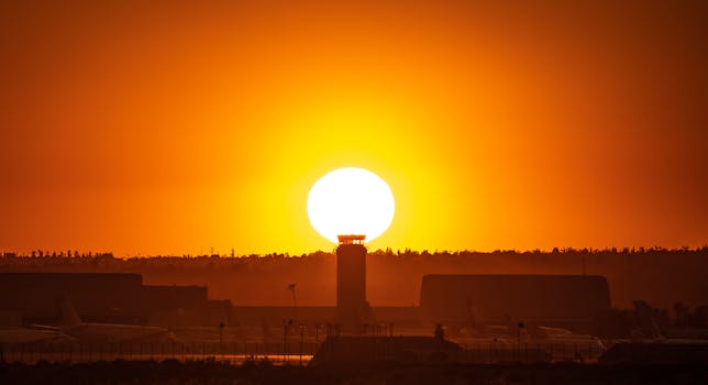 Dramatic sunset over San Bernardino airport with striking silhouette and vibrant orange skies.