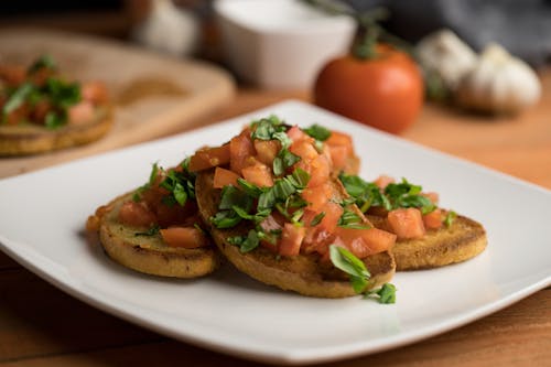 Free Photo of Chopped Tomatoes on Top of Toasted Bread Stock Photo