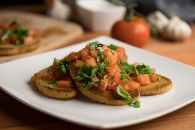 Toasts topped with chopped tomato and herbs — Mateusz Feliksik on Pexels