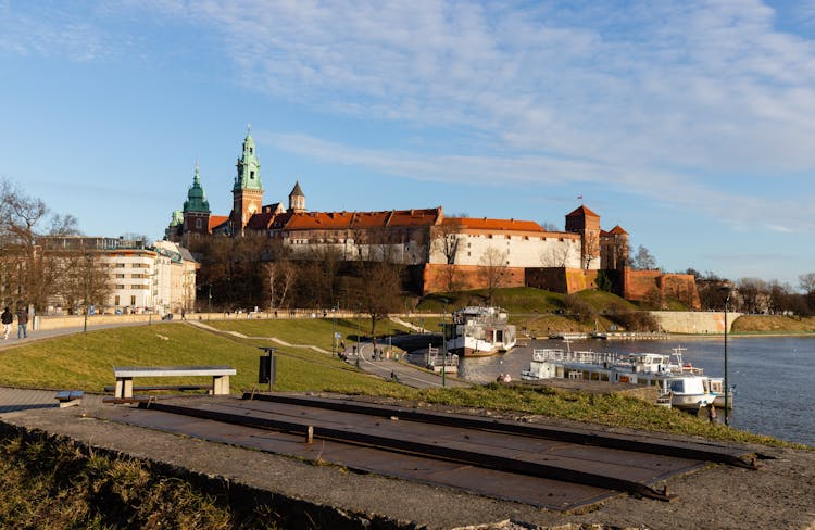 Royal Castle Near River In Krakow