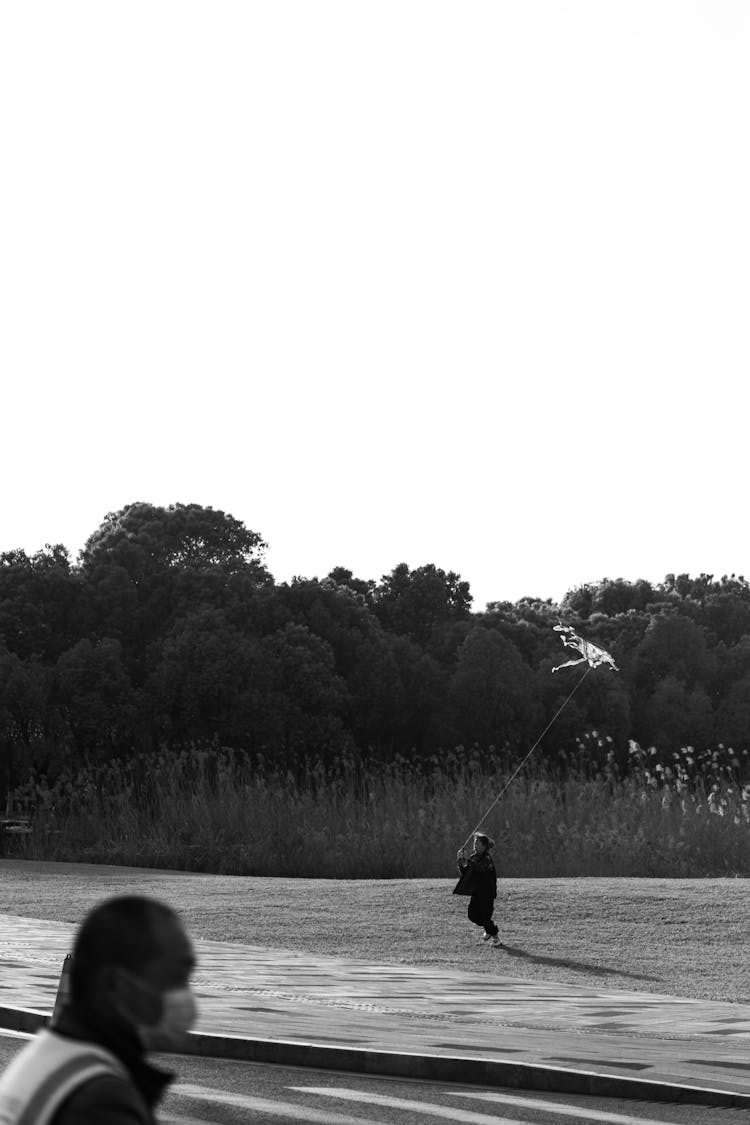 Man And Child Running With Kite Behind