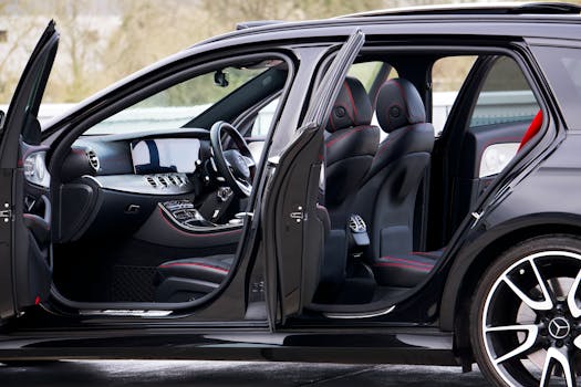 High-end black car showcasing luxurious interior design with open doors.