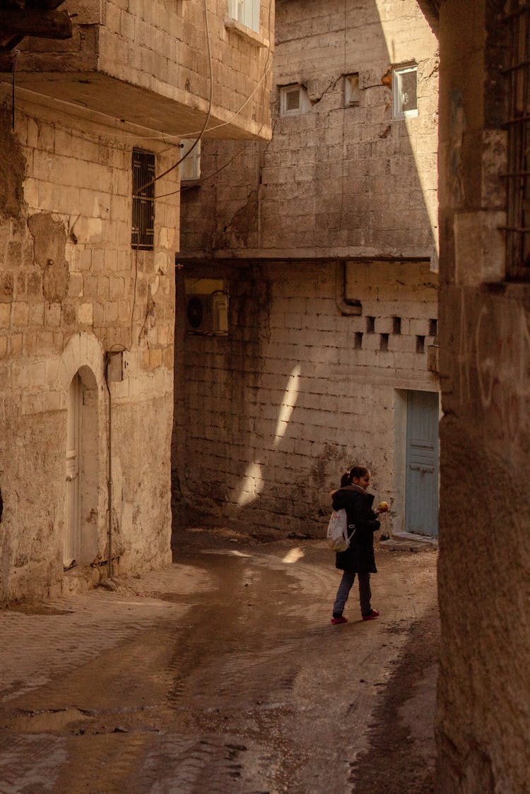 Girl Walking With Backpack In Alley 