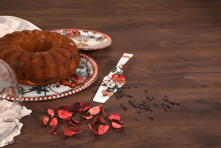 Photograph Of A Bundt Cake Near Dry Petals