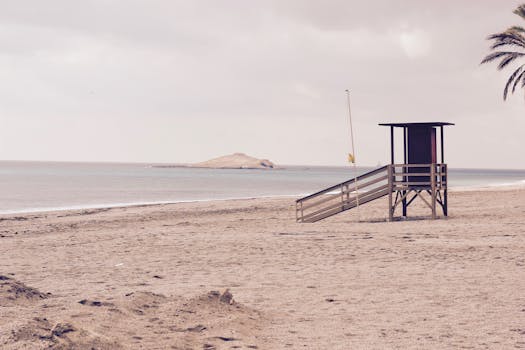 Peaceful beach scene with empty lifeguard tower near Madrid, Spain.