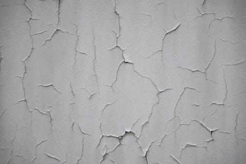 Photograph of a White Wall with Cracks