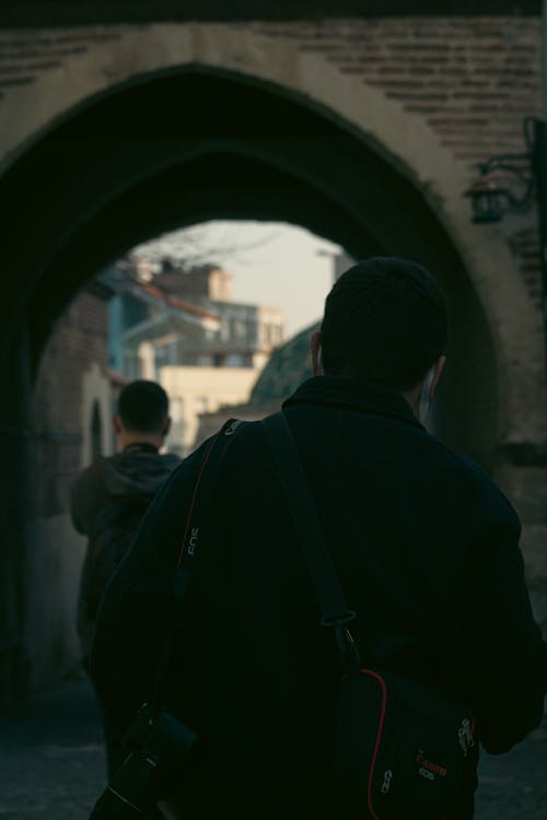 A Man Carrying a Camera