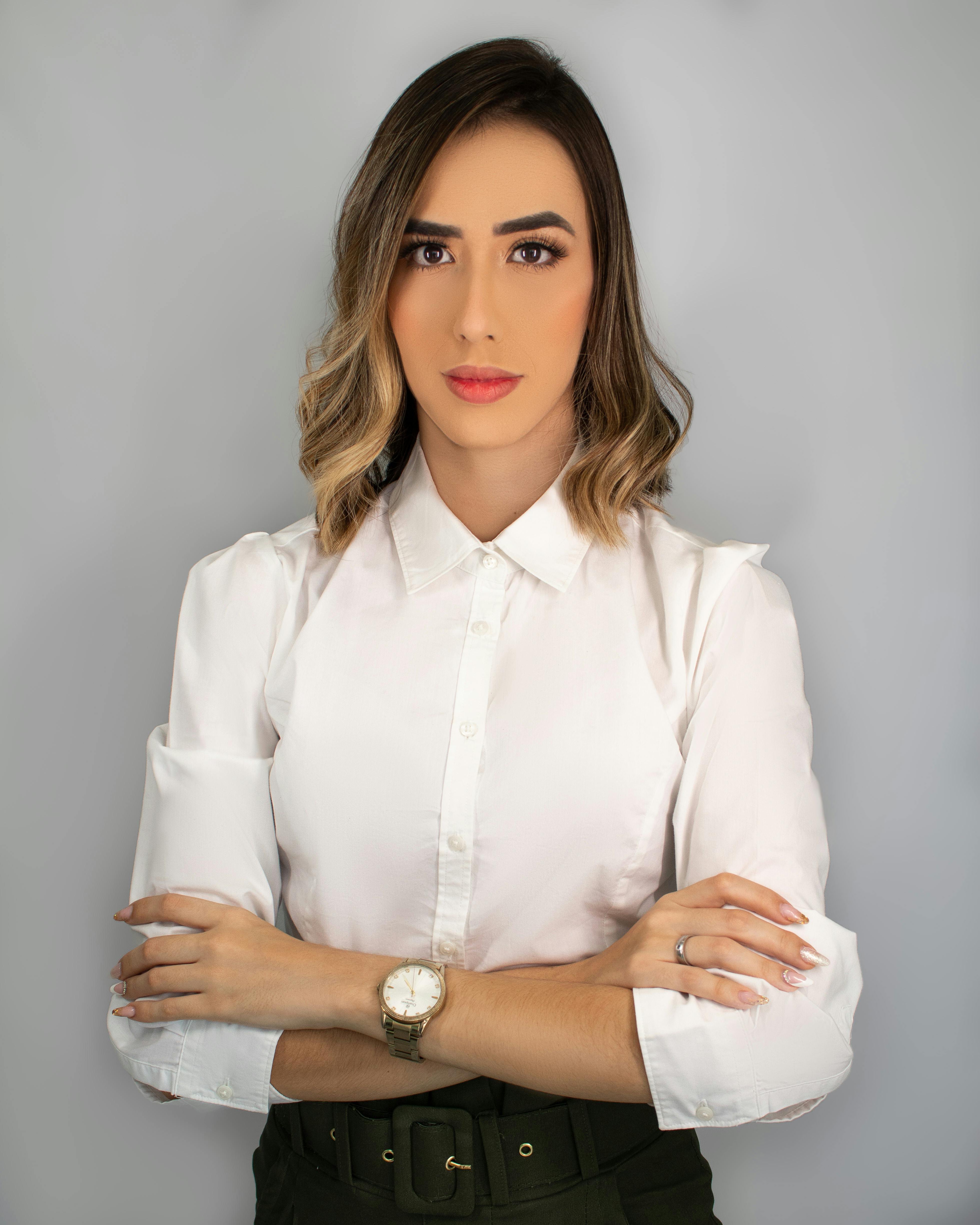 Elegant Middle Aged Woman With Her Arms Crossed Against White