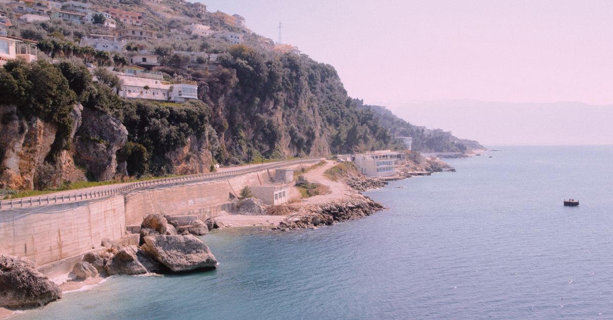 Albanian Riviera turquoise coastline with stone beach and mountains